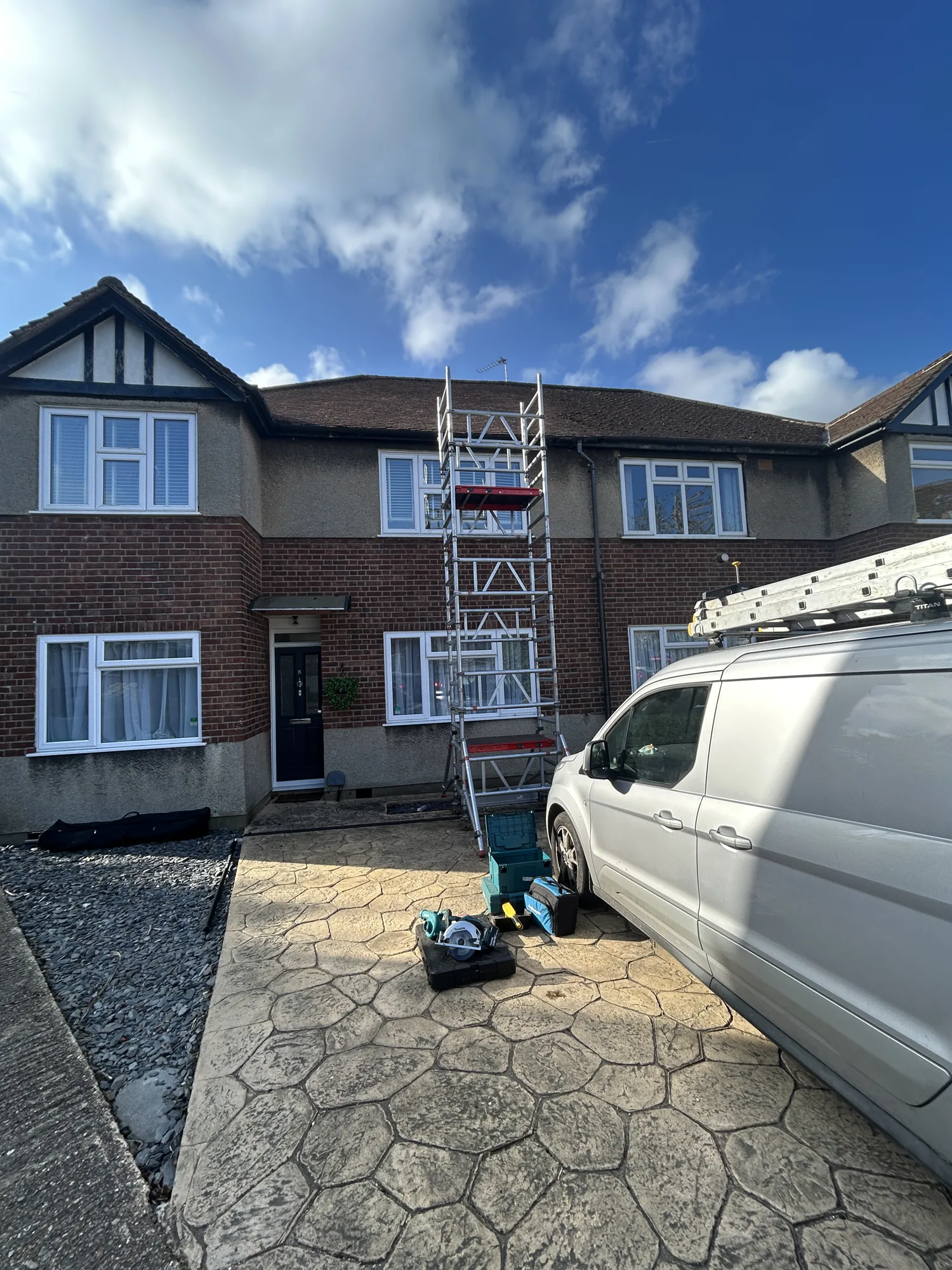 Scaffold tower set up against a house for exterior roof cleaning